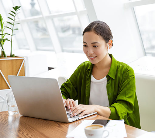 a human using a laptop sitting at a table